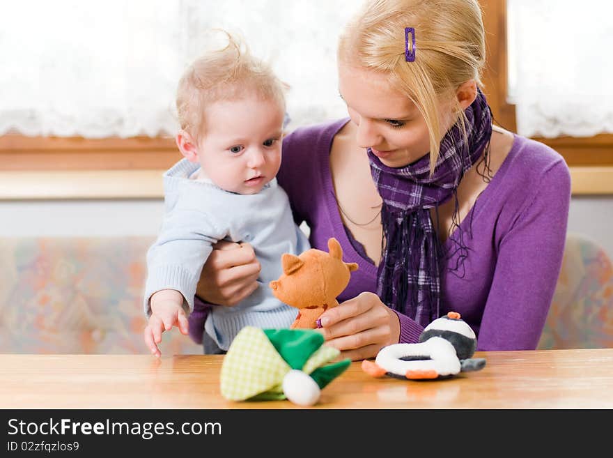 Young mother plays with her baby with toys. Young mother plays with her baby with toys