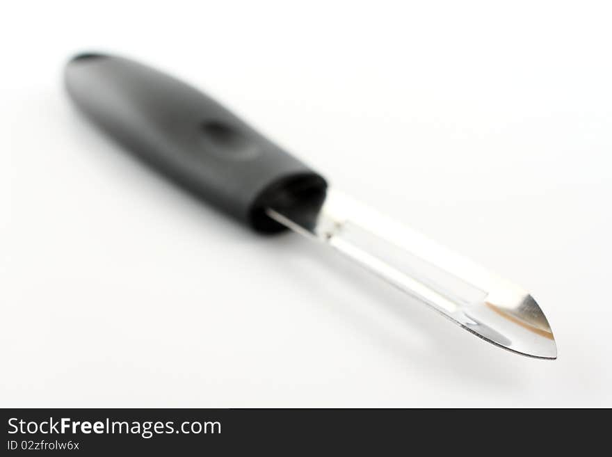 Small knife for fruit axis on white paper. Small knife for fruit axis on white paper.