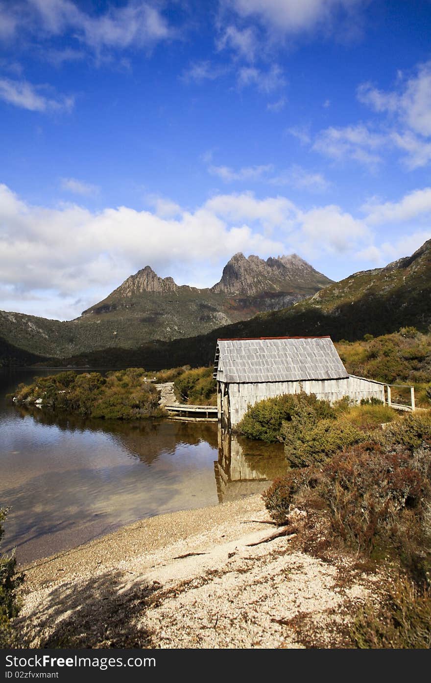 This photo was taken on a mountain in Tasmania. Beautiful landscape with sky, clouds, mountain, lake and a small log cabin. beautiful as a painting. This photo was taken on a mountain in Tasmania. Beautiful landscape with sky, clouds, mountain, lake and a small log cabin. beautiful as a painting.