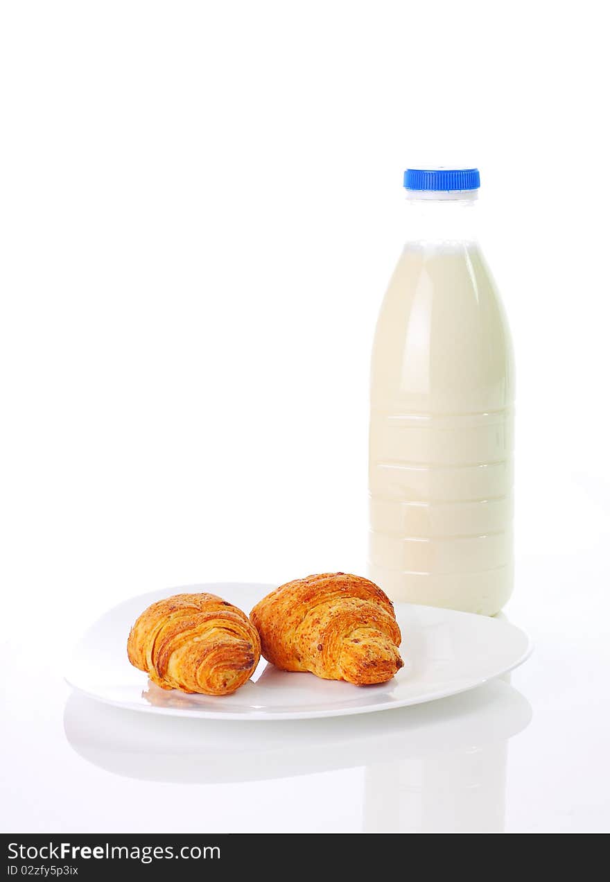 Croissants and milk on white background