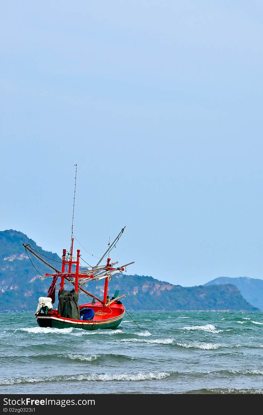 Red fishing boat on the sea