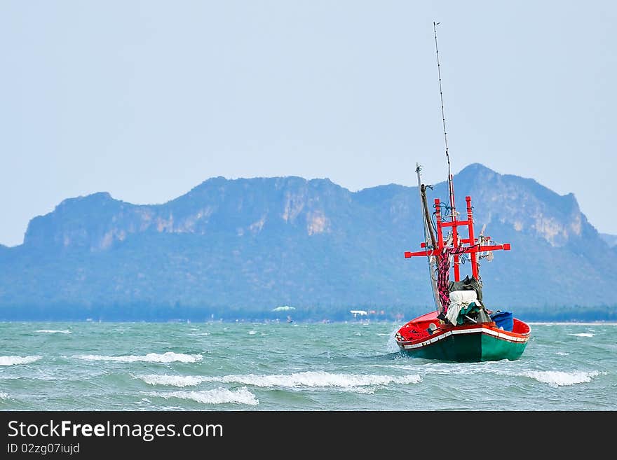 Red fishing boat on the sea