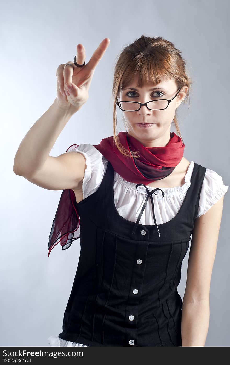 Blonde girl with glasses, pen and book that makes a teacher