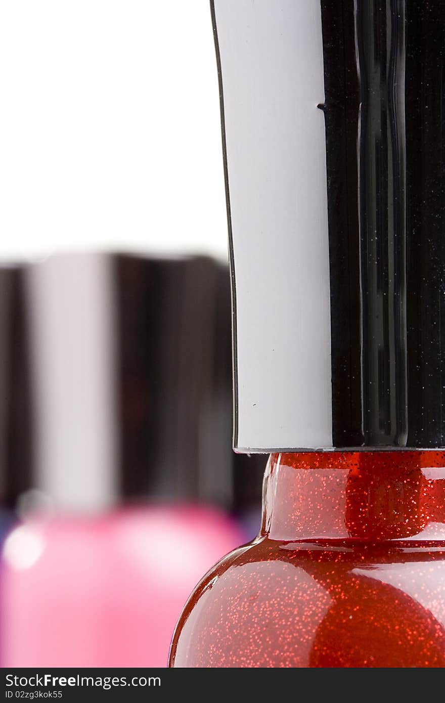 Red nail polish bottle with a black cap.