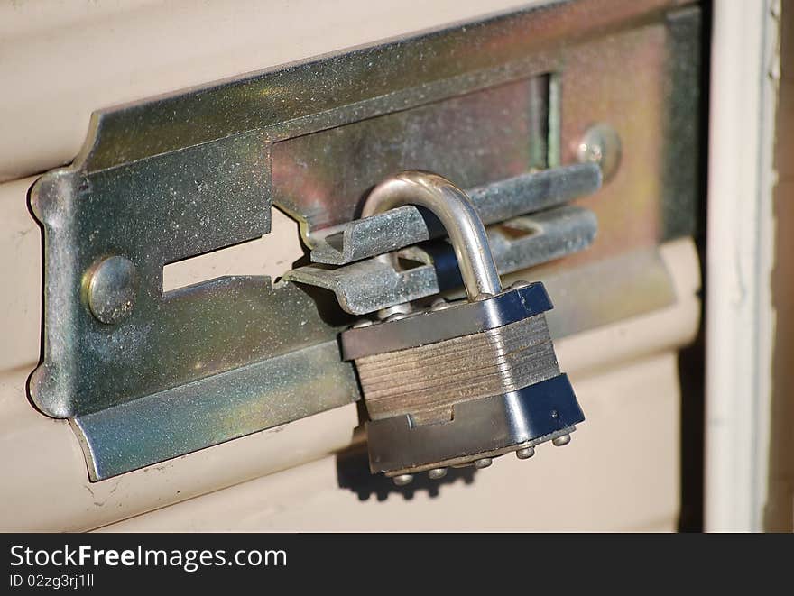 Padlock closes the door warehouse made of metal.