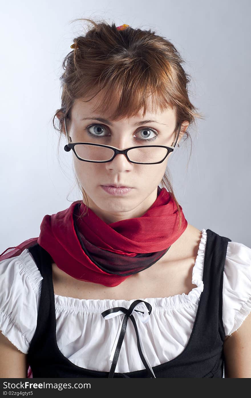 Blonde girl with glasses, pen and book that makes a teacher