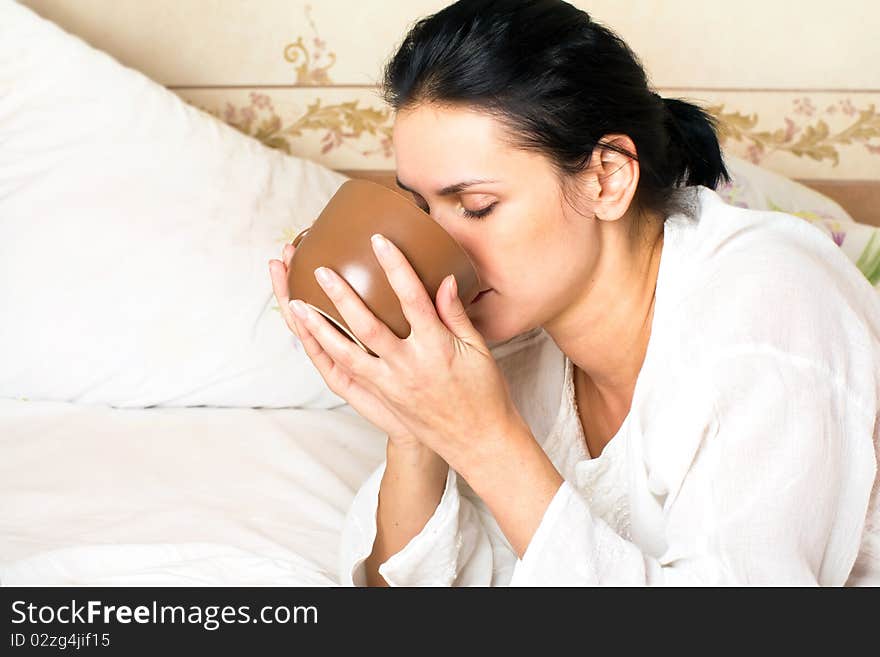 A young woman drinking coffee