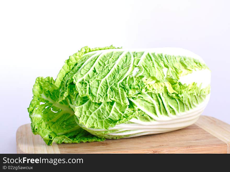 Fresh cabbage on the wood desk isolated on the white background