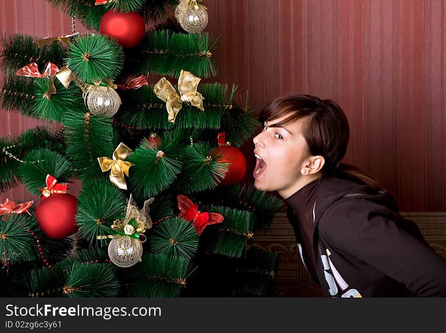 Funny girl near the Christmas tree. Funny girl near the Christmas tree