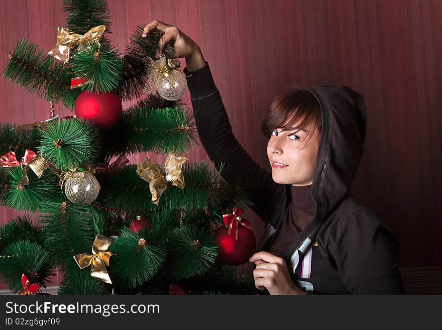 Funny girl decorates the Christmas tree