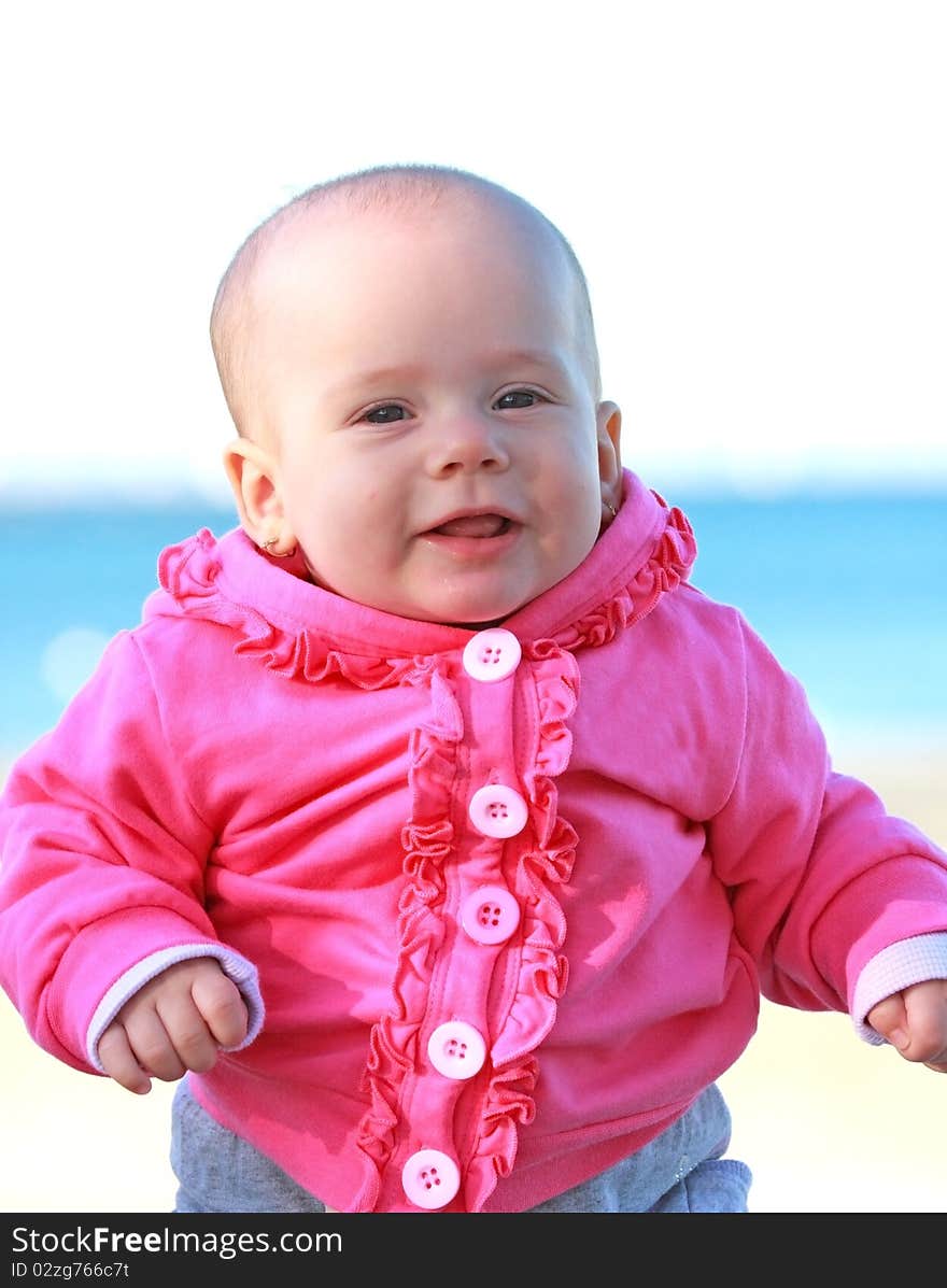 Happy baby girl with pink jacket smiling. Happy baby girl with pink jacket smiling