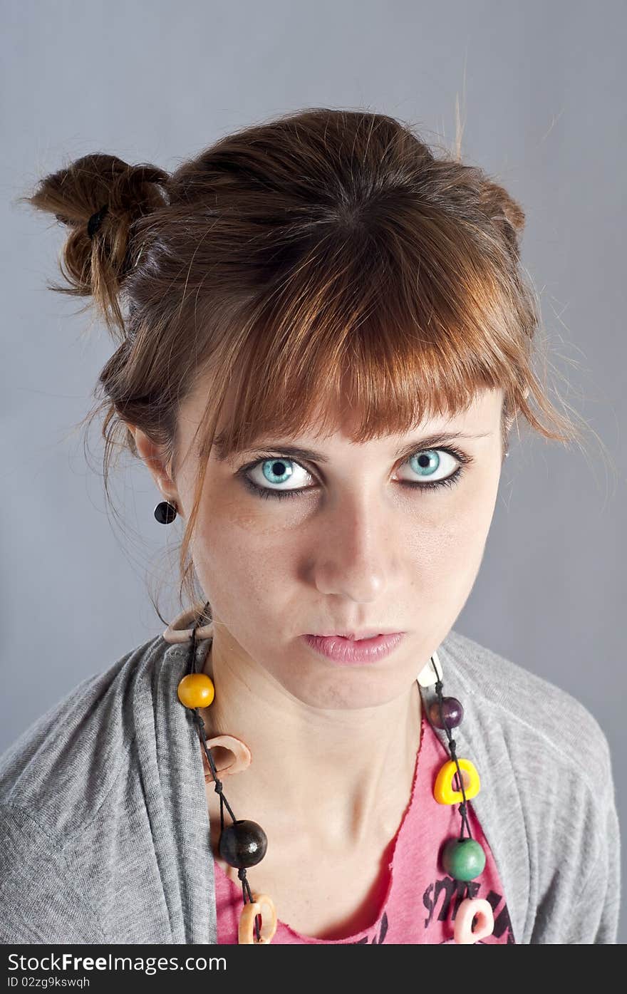 Young girl with pigtails, and colorful necklace