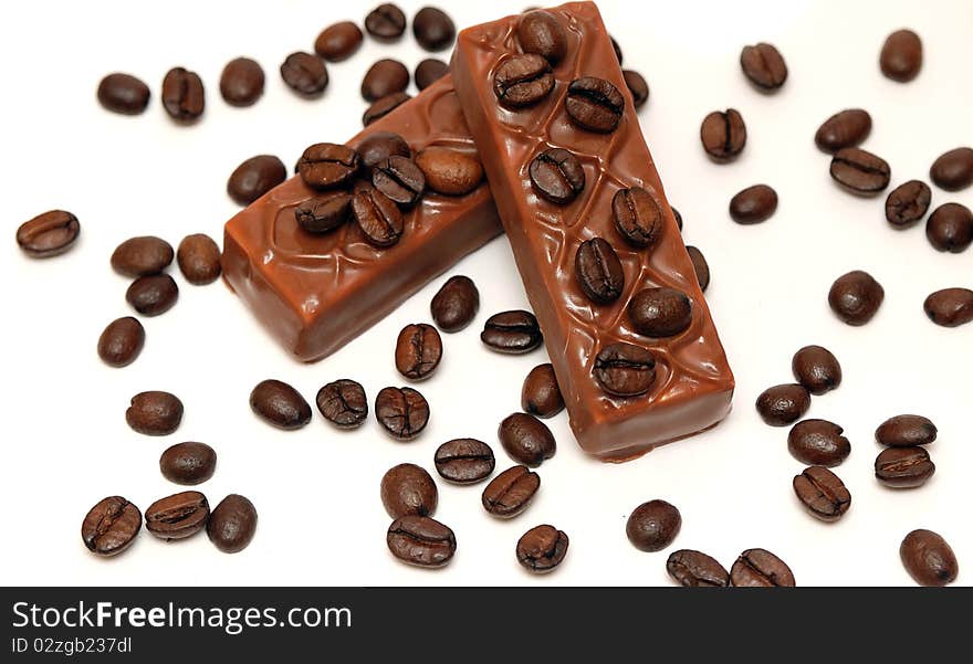 Coffee beans and chocolate on white background. Coffee beans and chocolate on white background