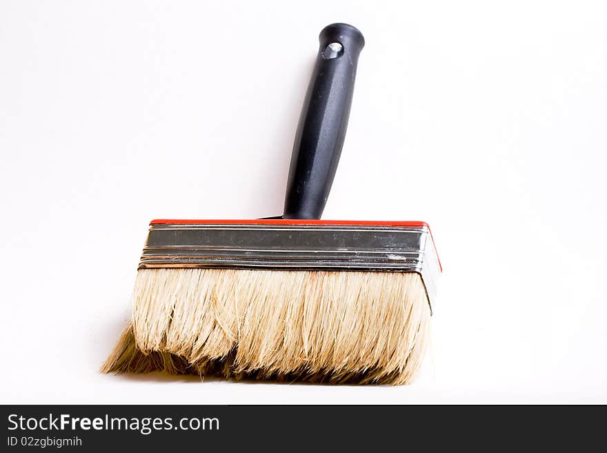 Red paint brush on a white background