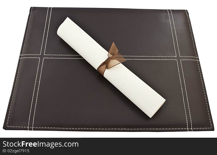 Diploma on top of a brown leather portfolia and isolated on a white background. Diploma on top of a brown leather portfolia and isolated on a white background