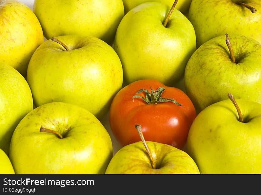 Red ripe tomatoes lying in green apples. Red ripe tomatoes lying in green apples