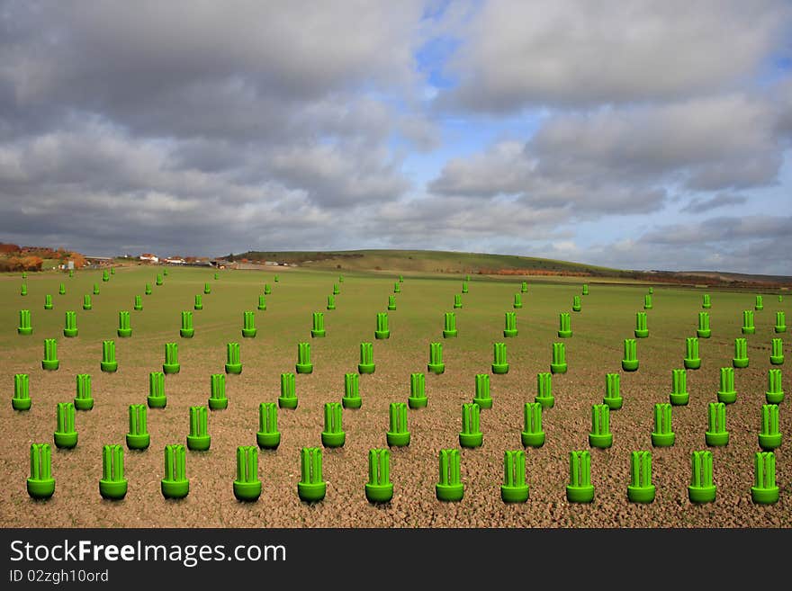 Green energy bulbs growing in a field