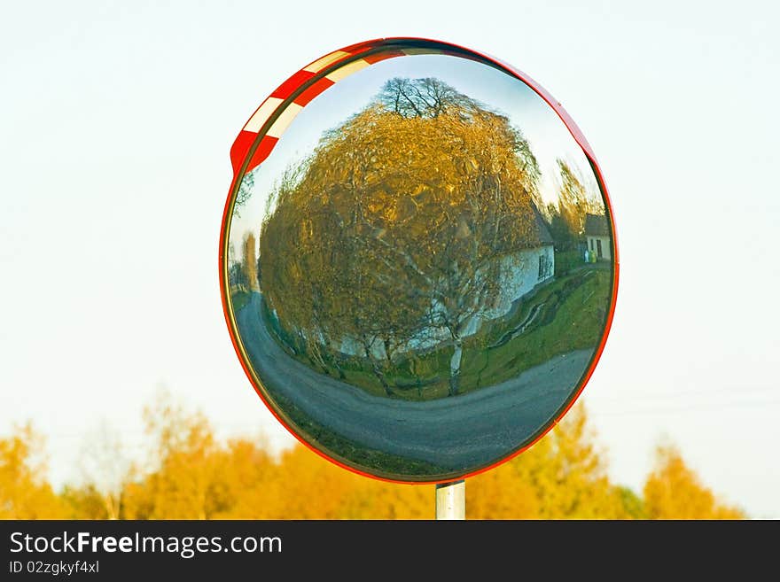 Mirror near road in which the reflects autumn landscape. Mirror near road in which the reflects autumn landscape.