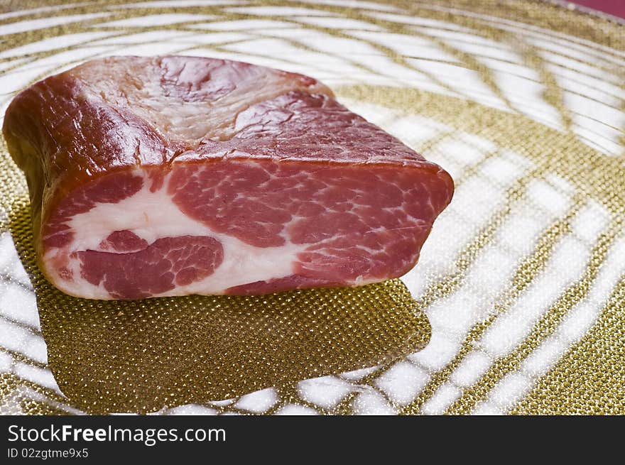 Raw meat on a plate over color background