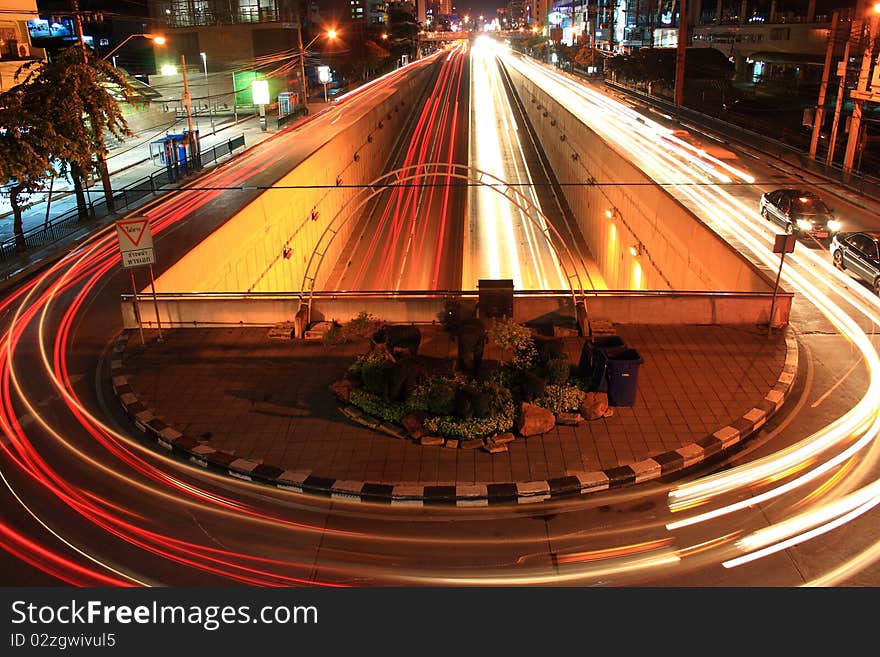 Traffic turning at a light signal at night. Traffic turning at a light signal at night