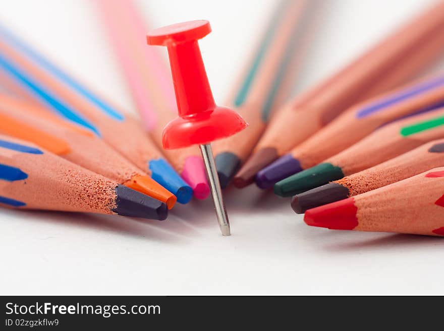 Closeup photo of pin and pencil over white background. Closeup photo of pin and pencil over white background