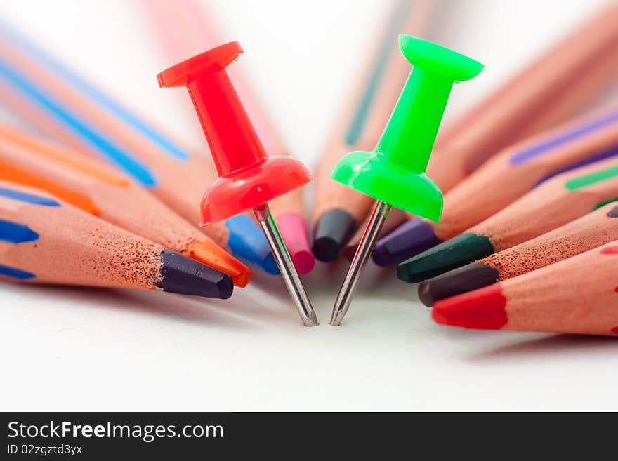 Closeup photo of pencils and pins on white. Closeup photo of pencils and pins on white