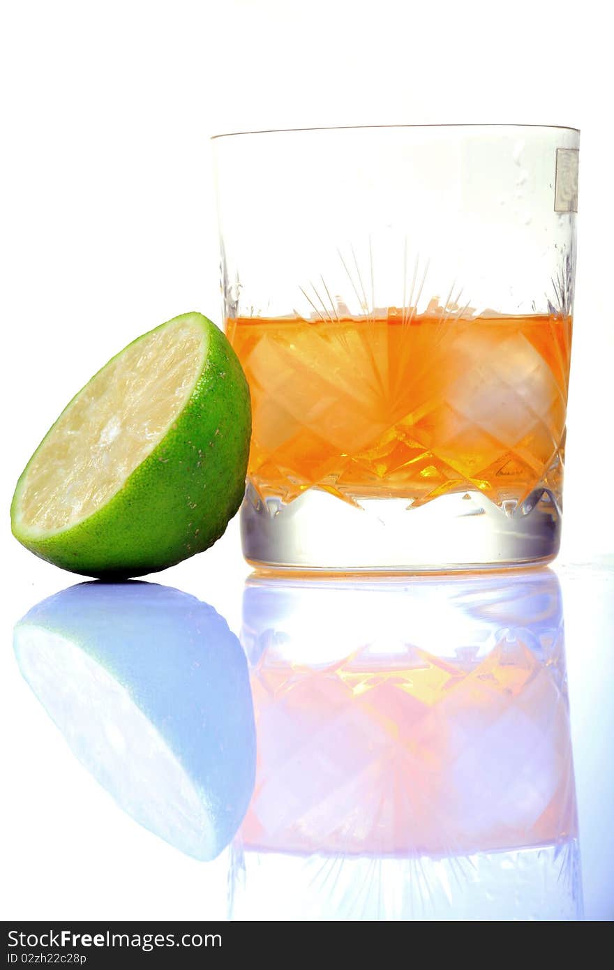 Whiskey glass with lemon with white background.