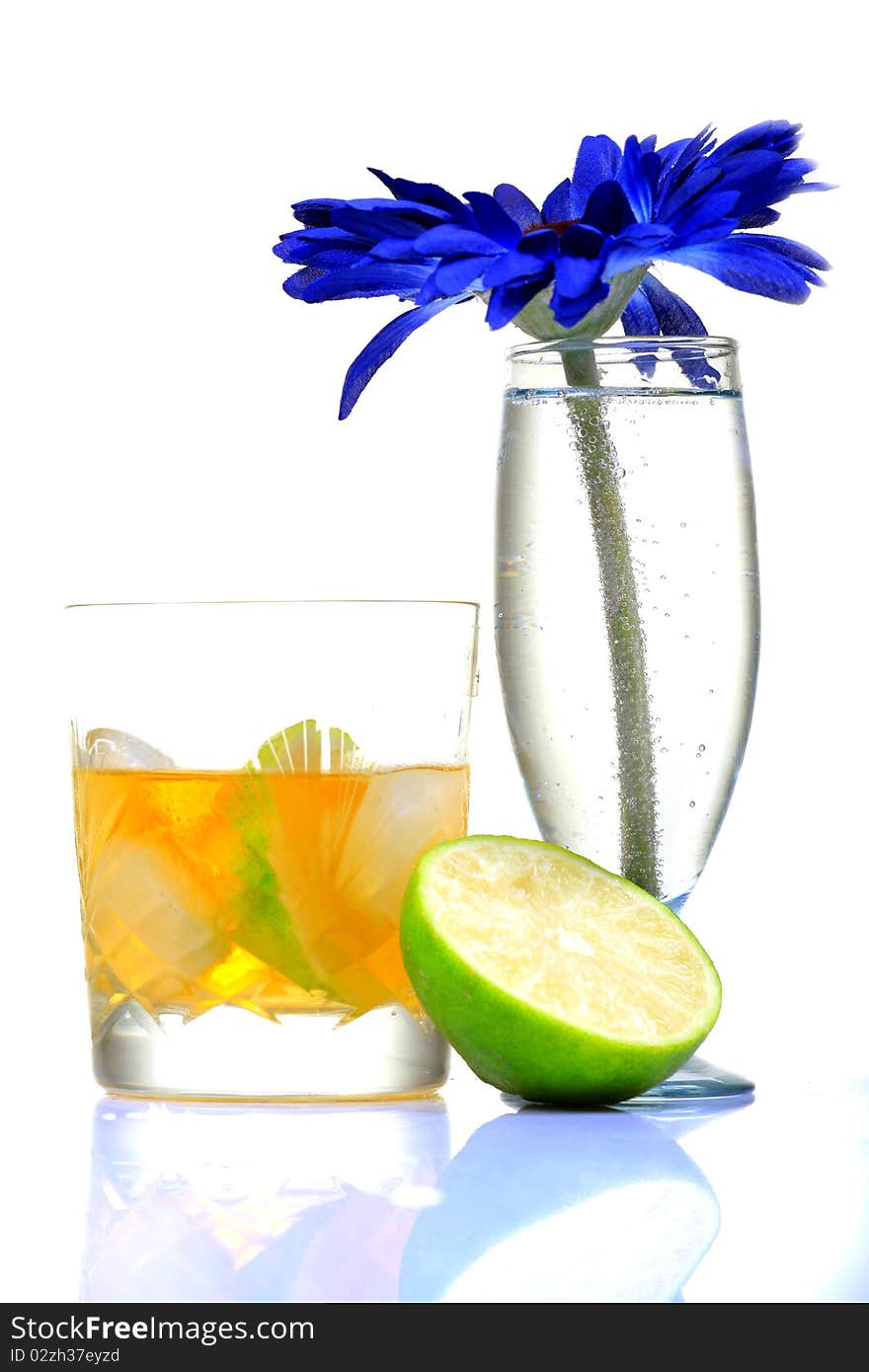 Tropical whiskey glass with lime on white background.