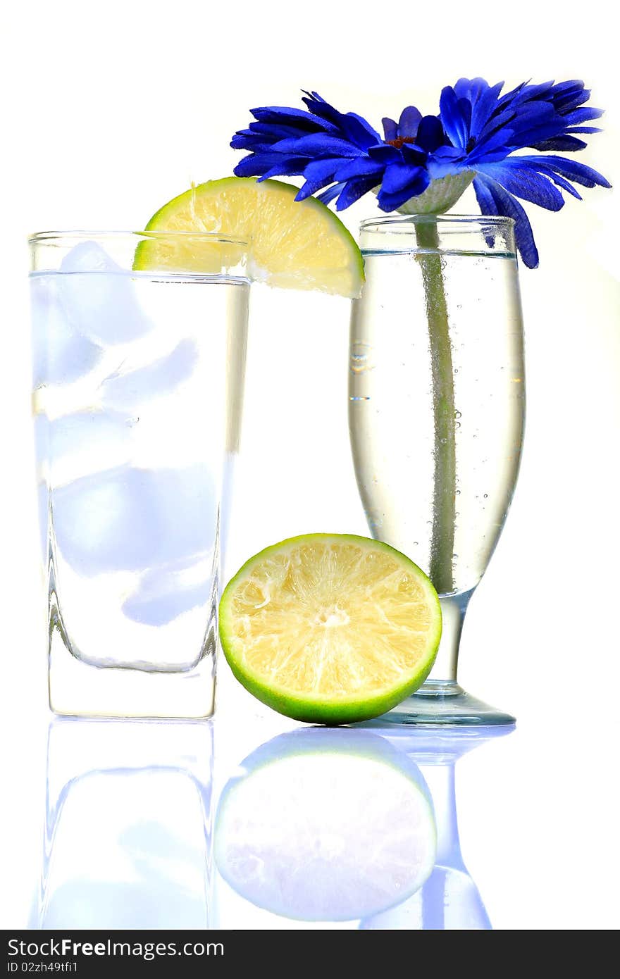 White wine glasses with lemon on white background.