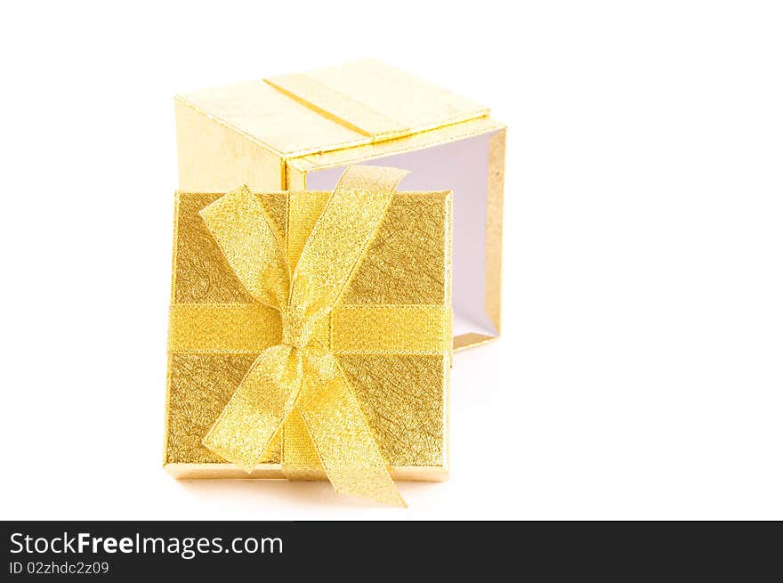 Christmas open giftbox on white background, with golden ribbon. Christmas open giftbox on white background, with golden ribbon