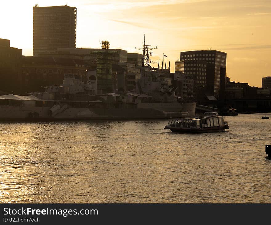 War ship on river thames at sunset in london