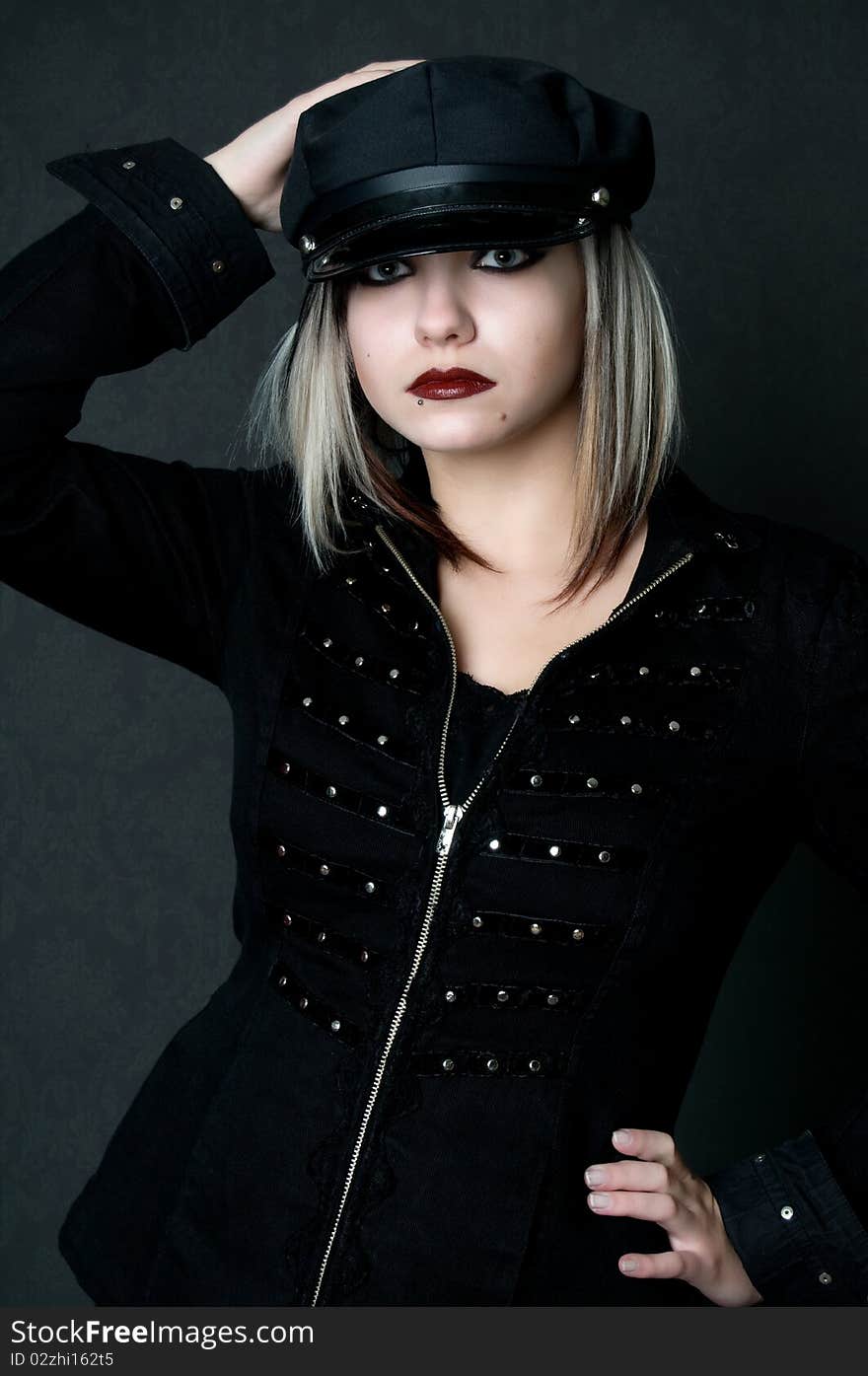 Sexy young woman wearing thick black eyeliner and black cap