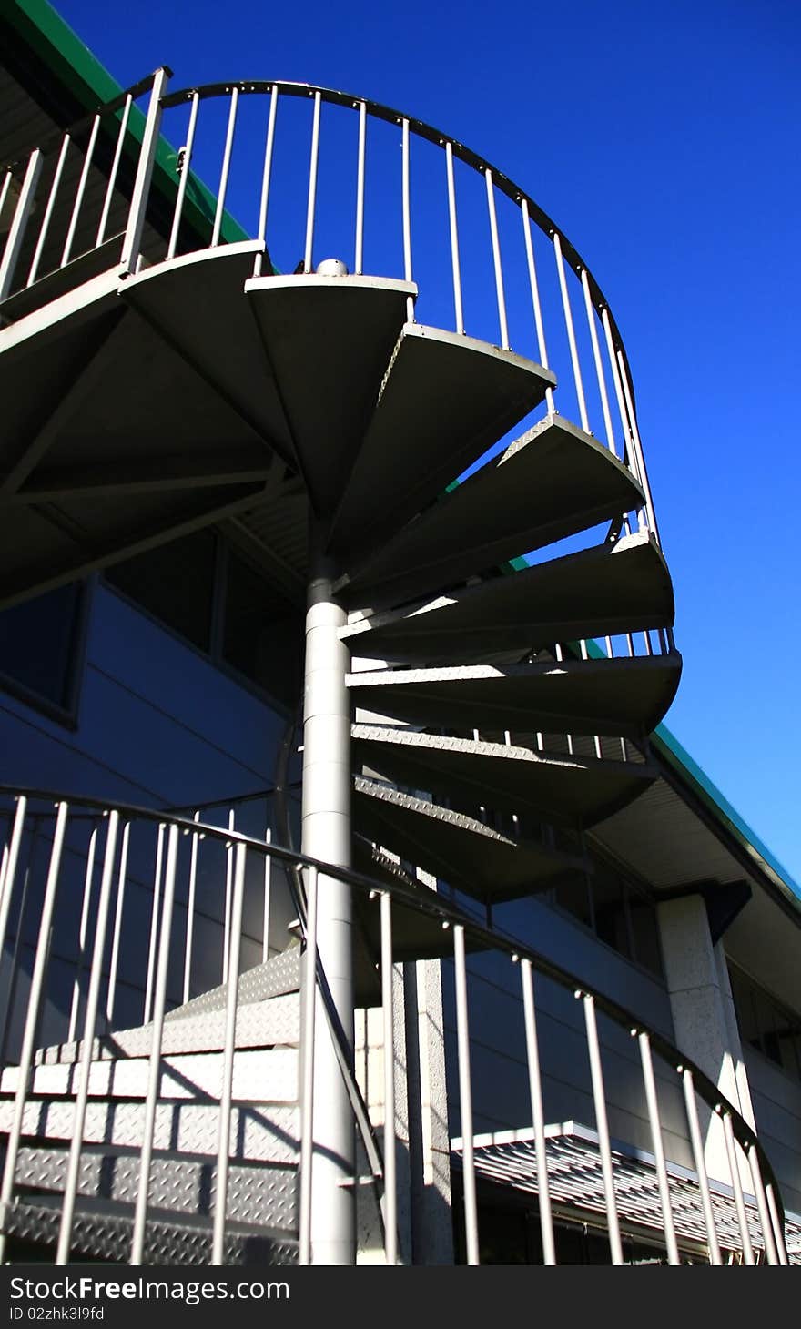 Image of a spiral staircase with blue sky background. Image of a spiral staircase with blue sky background