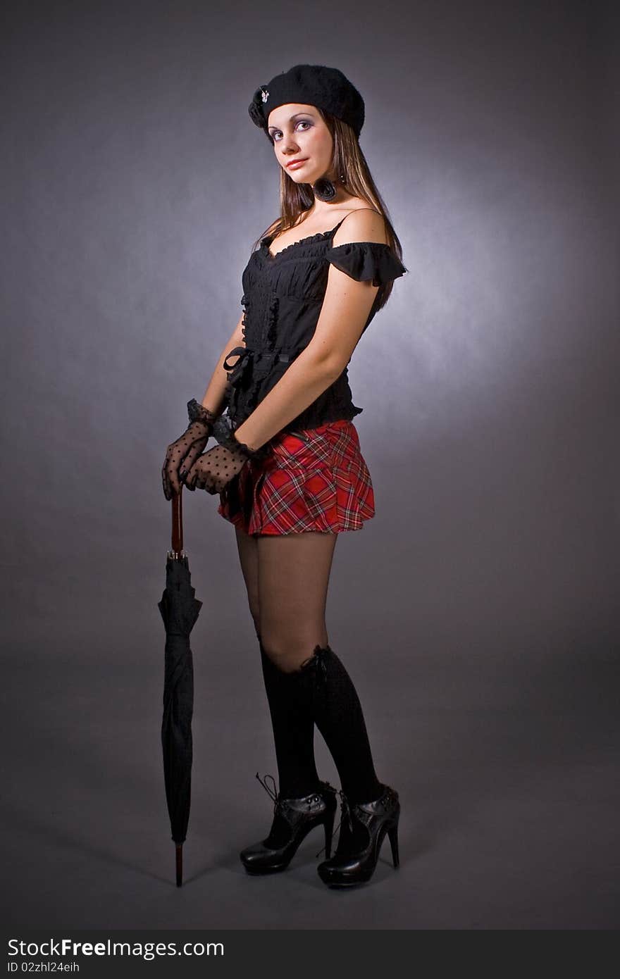 Gothic girl in mini skirt with umbrella