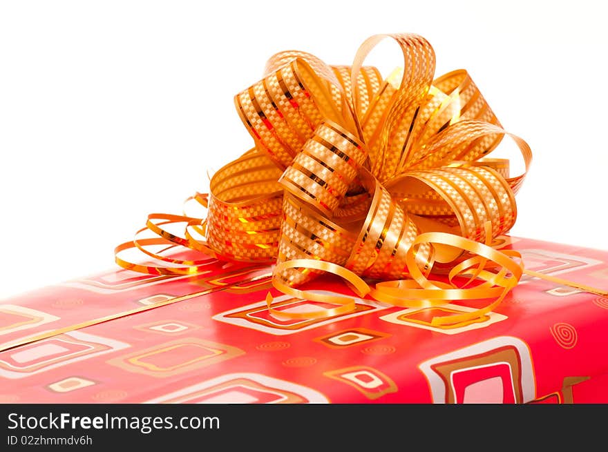 Red gift box with ribbon and bow on white background