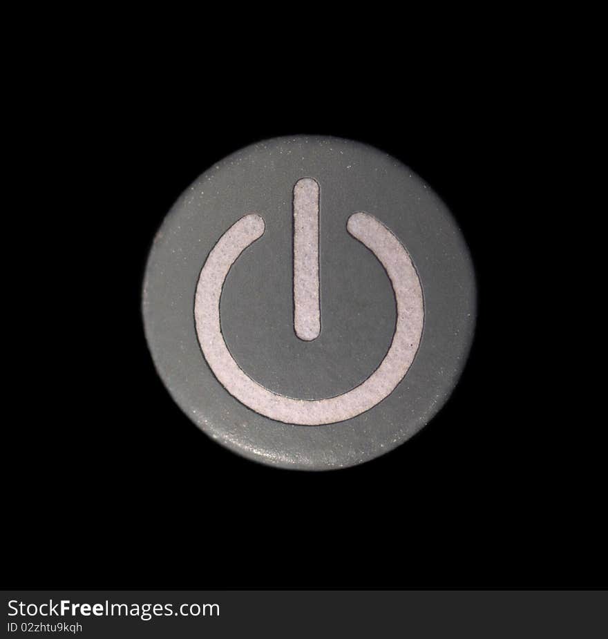 Macro of a Grey Colored Power Button Isolated on Black. Macro of a Grey Colored Power Button Isolated on Black