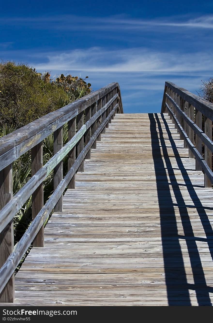 Walk bridge leading to the ocean over the hill. Walk bridge leading to the ocean over the hill.