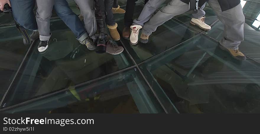 A group of young men stand together, display their shoes. This is a dynamic, a youth-specific activity.