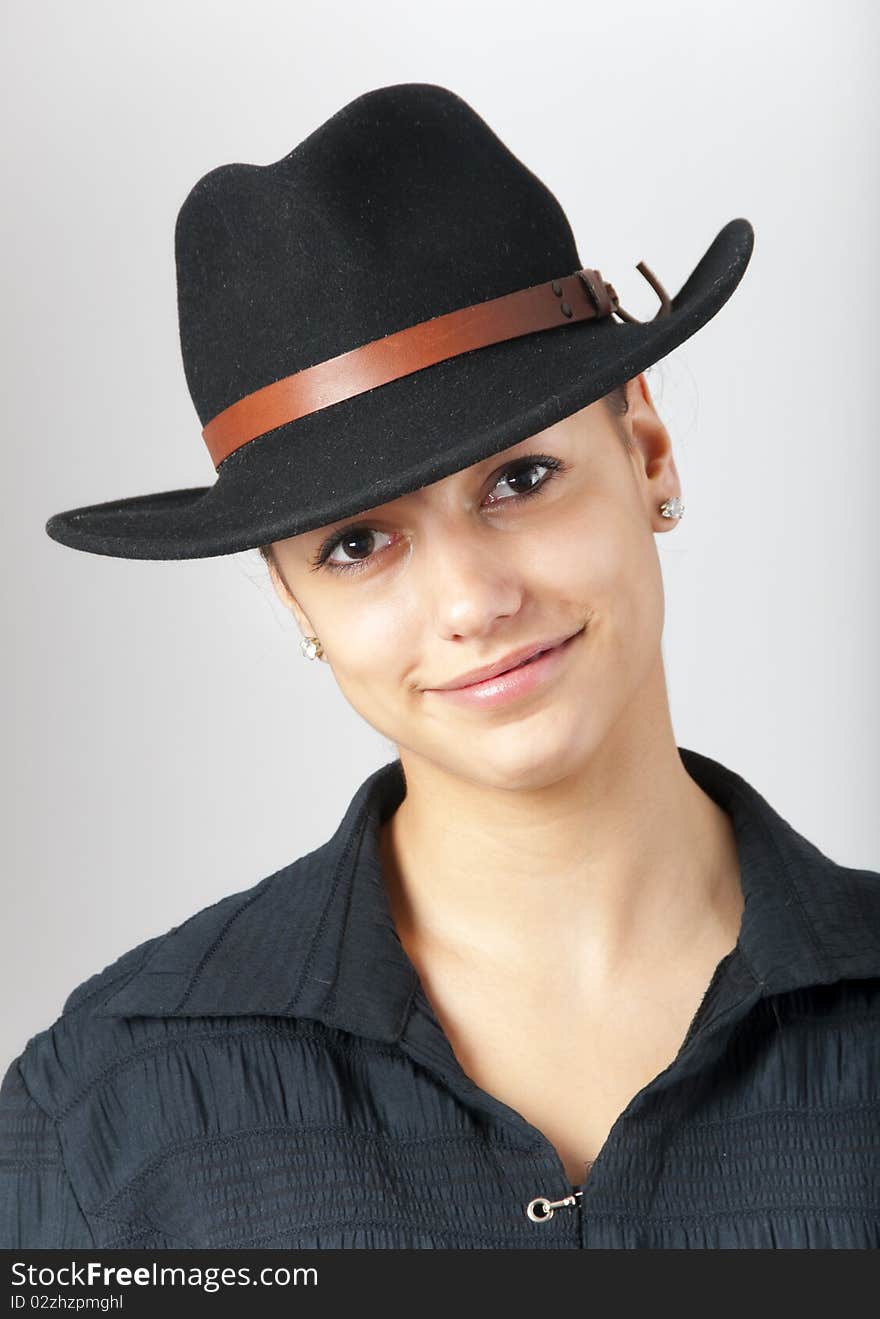 Portrait of the beautiful teenage girl wearing black cowboy hat. Portrait of the beautiful teenage girl wearing black cowboy hat.