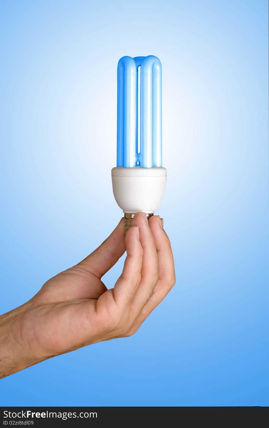 Hand holding an energy-saving lamp. Hand holding an energy-saving lamp