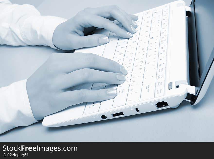 Hands of a young girl running on a computer in the office