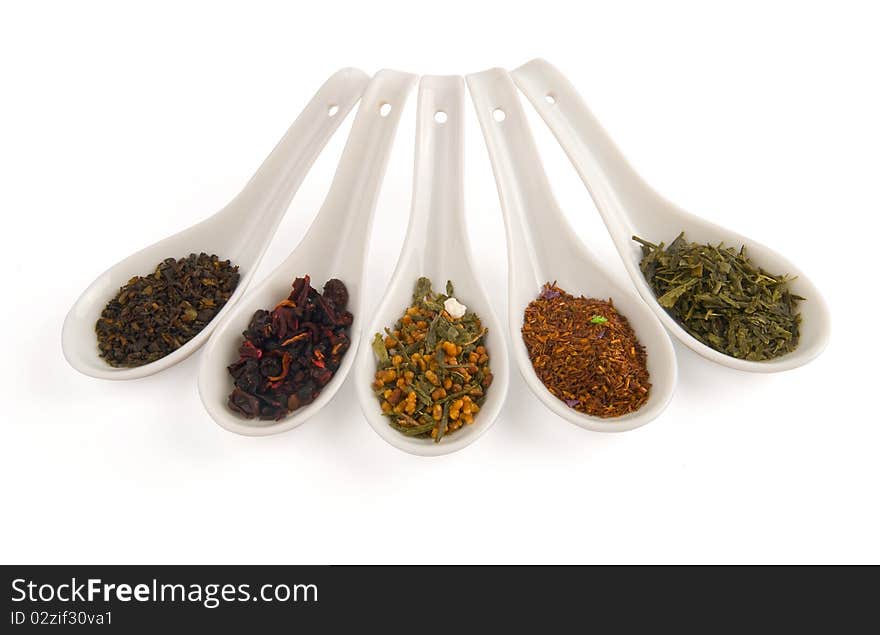 Chinese spoons with tea on white background.