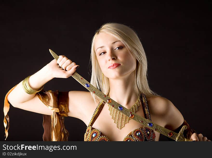 Young beauty blond girl with saber - arabia costume. Young beauty blond girl with saber - arabia costume