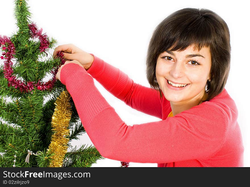 Young woman decorating christmas tree