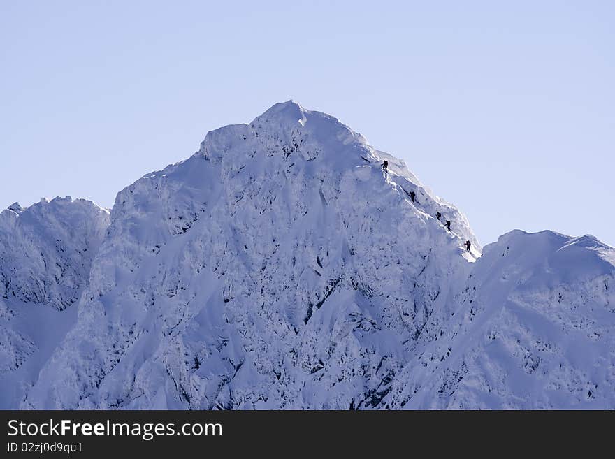 Group of climbers approaching a snowy peak