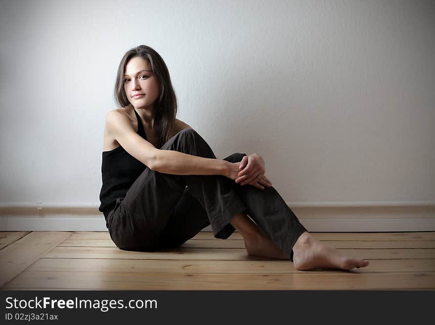 Beautiful woman sitting on the floor at home