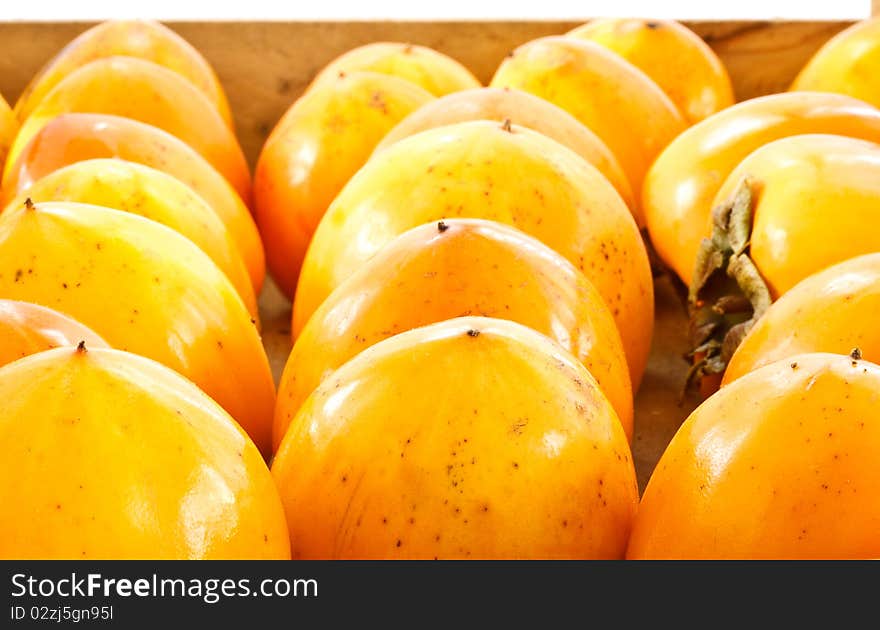 A lot of persimmons folded into a box before selling