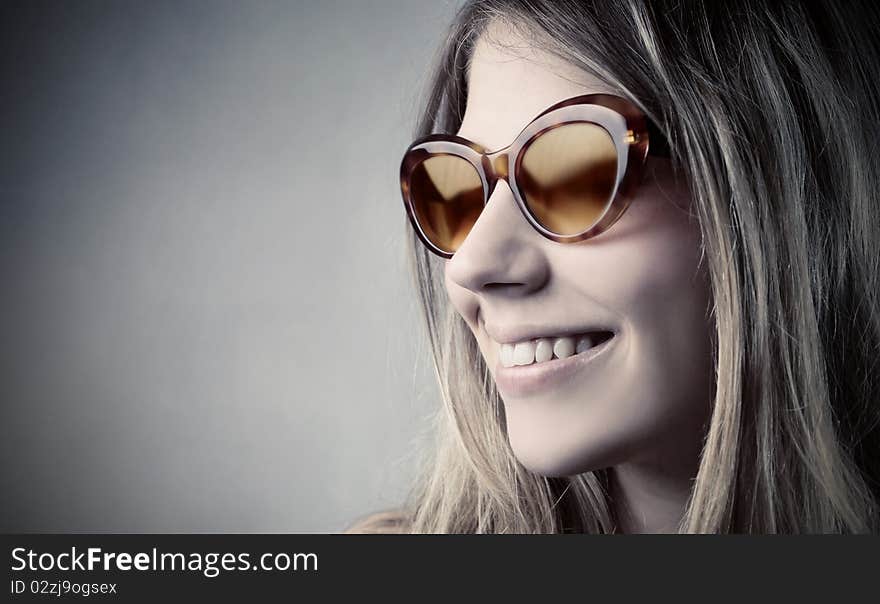 Smiling beautiful woman wearing sunglasses. Smiling beautiful woman wearing sunglasses