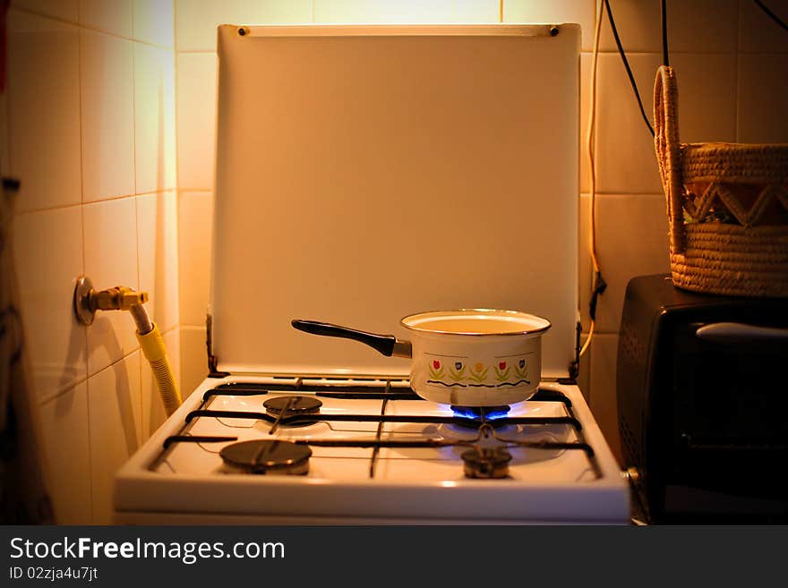 Pot containig water on an old oven. Pot containig water on an old oven