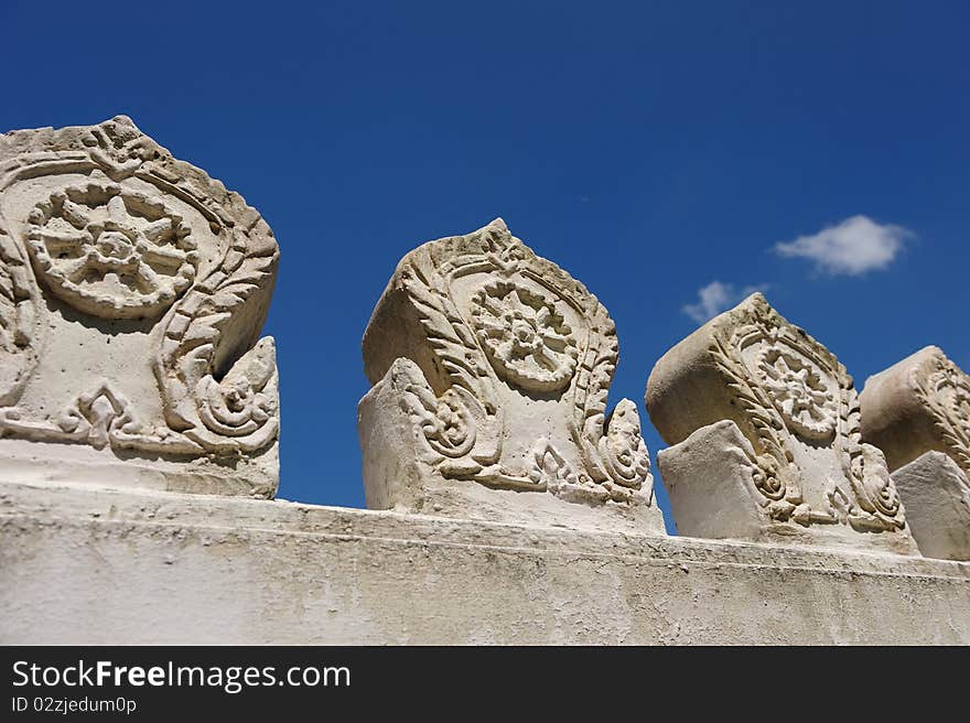 Wall of Buddhist Temple against blue sky